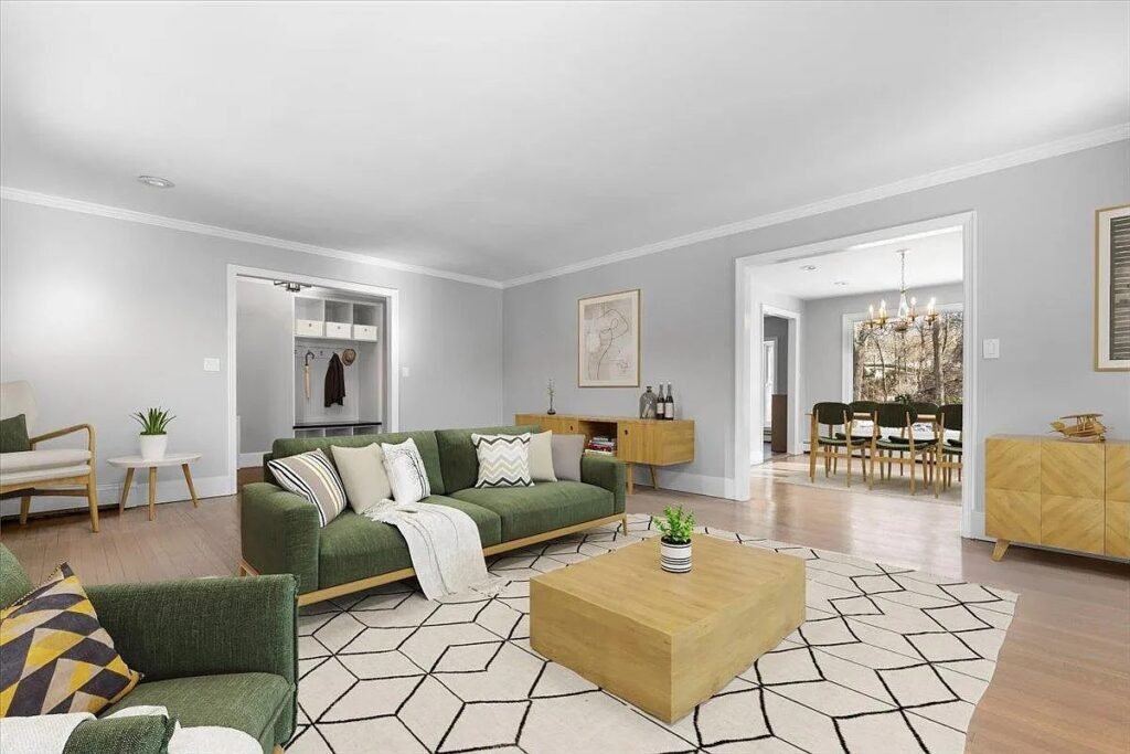 Renovated living room with new flooring and staged furniture