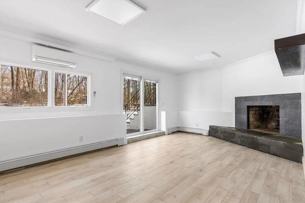Living room with the original fireplace and new hardwood floors