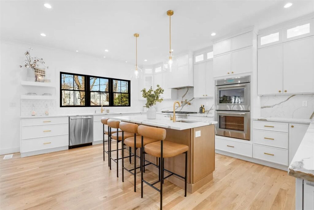 Kitchen island with counter stools and pendant lighting