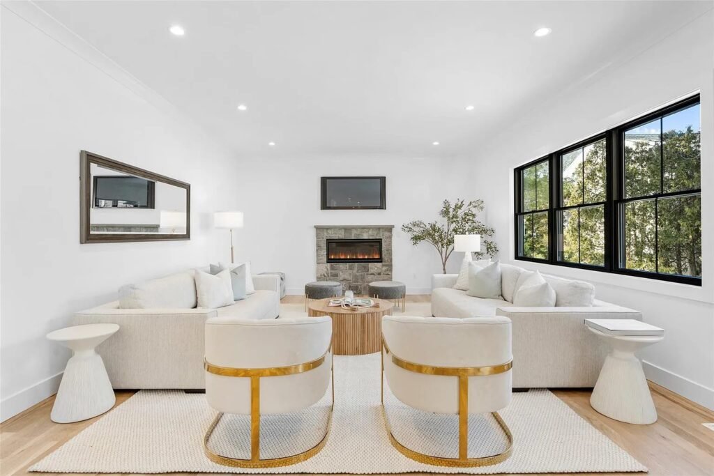 Living room with a linear fireplace and built-in millwork