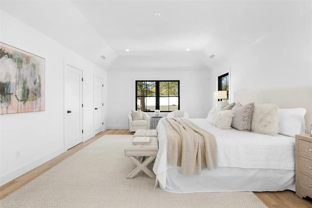 Bedroom with wide-plank oak flooring and en-suite access