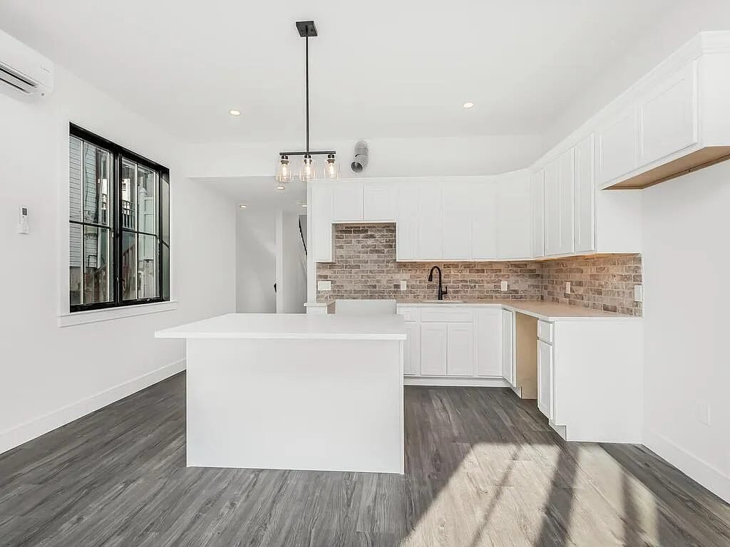Open living area with dark plank flooring
