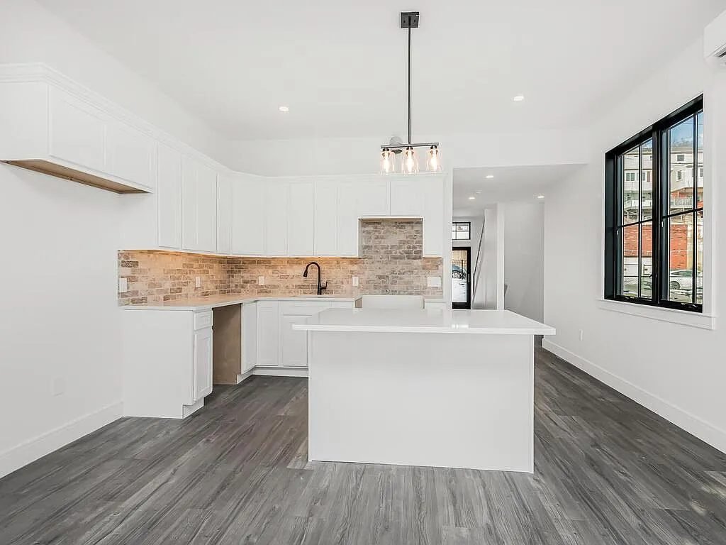 Kitchen with island and timber accent wall
