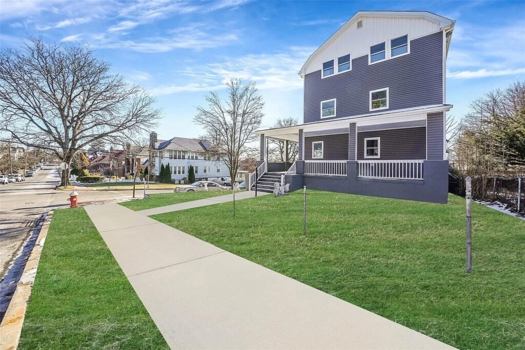 Renovated home exterior with front lawn and walkway