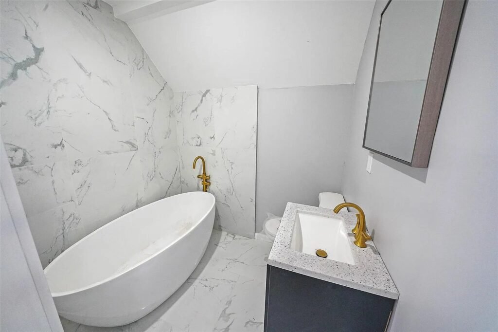 Bathroom with marble tile and freestanding tub