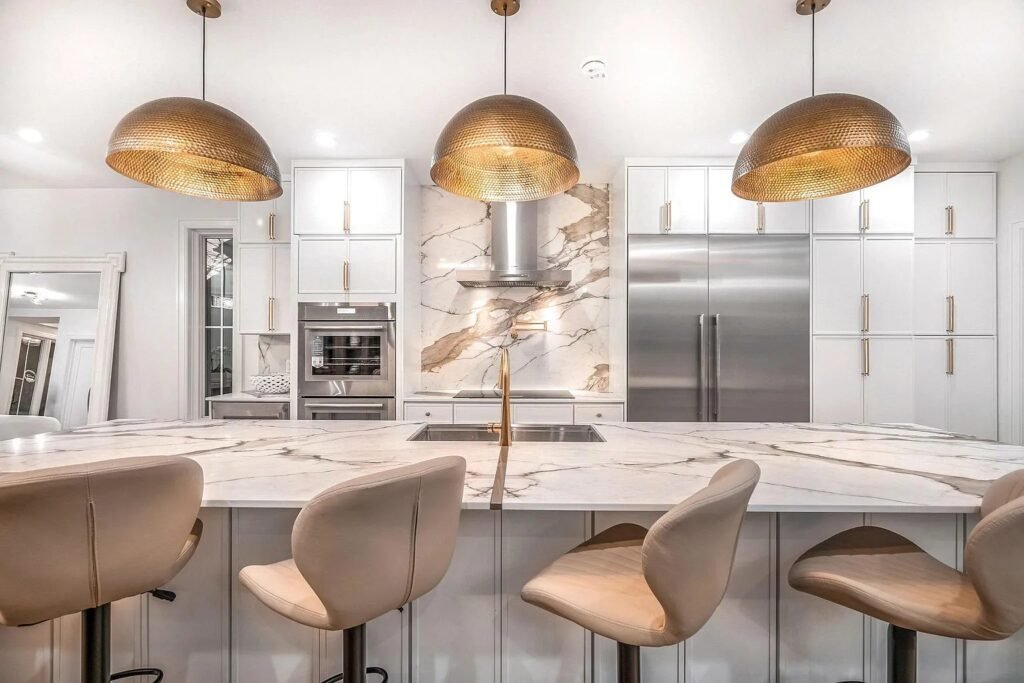 Kitchen with brass pendant lighting and full-height cabinetry