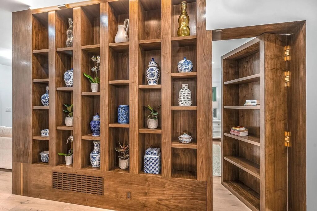 Custom walnut library shelving with glazed cabinet doors