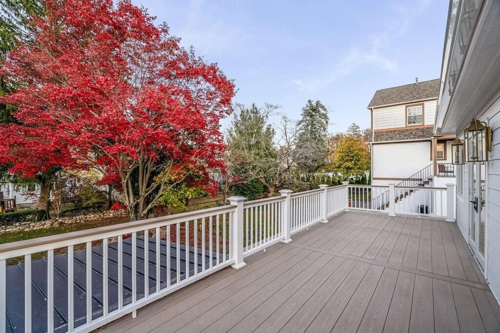 Rear deck framed by a red maple in autumn
