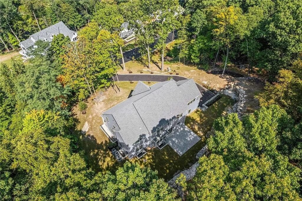 Aerial view of a completed Monvestor Construction Group home on a wooded Westchester site