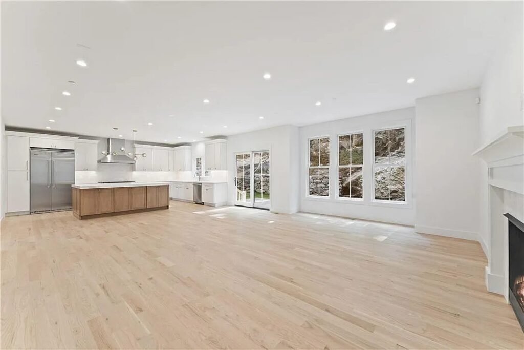 Open kitchen with island seating and adjoining family room