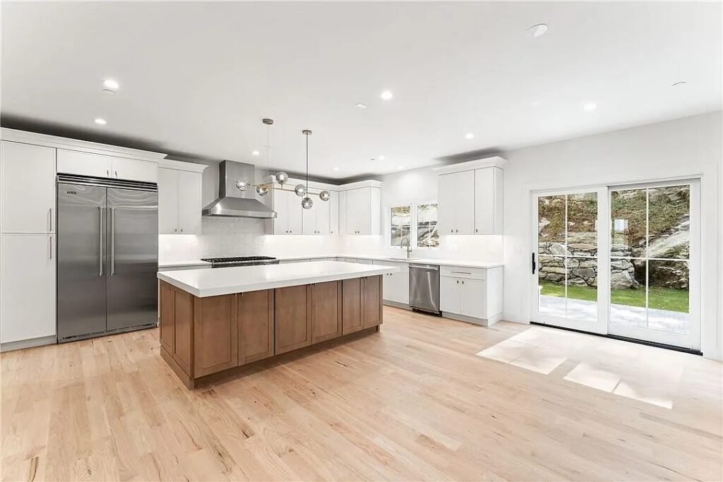 Kitchen with a stainless range and marble backsplash