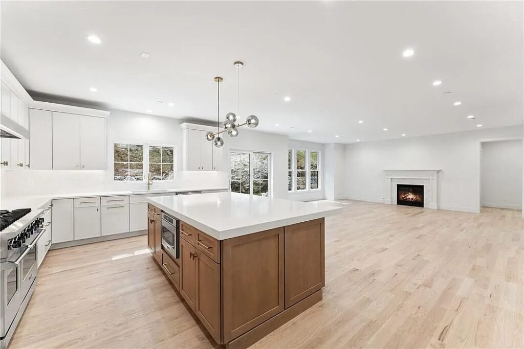 Kitchen and living space with a linear fireplace