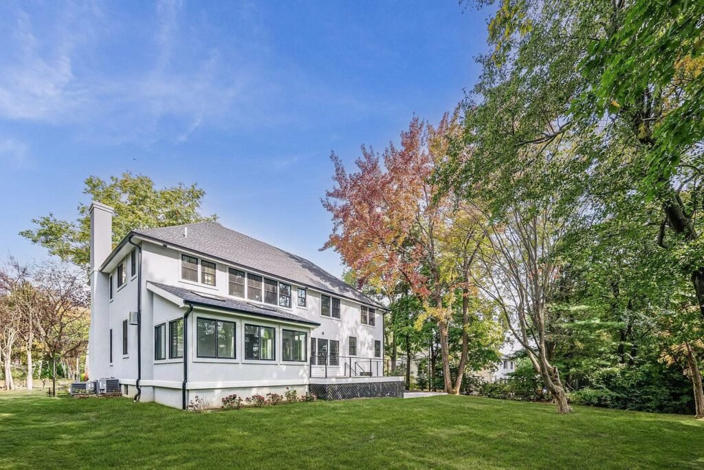 Front elevation in summer with mature planting