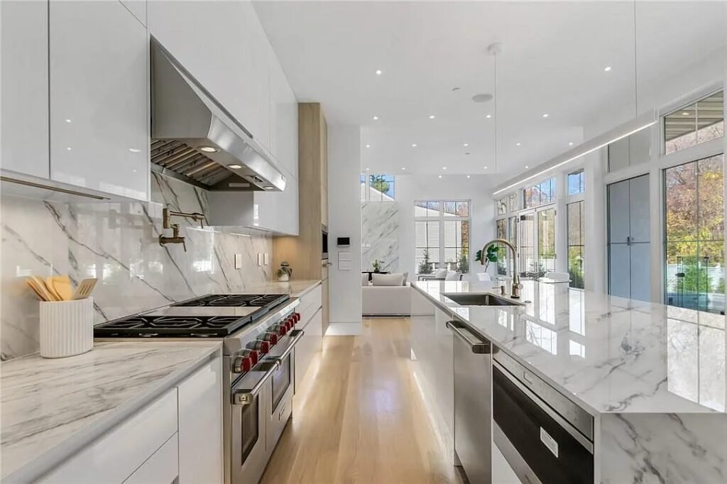 Kitchen range wall finished in book-matched marble