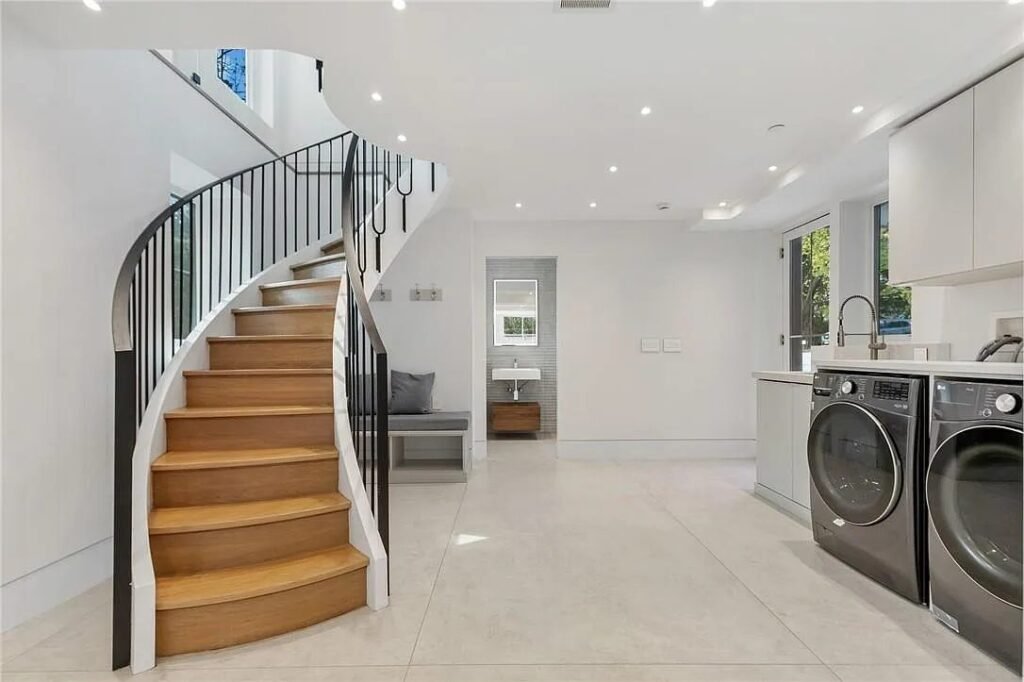 Curved staircase beside the service corridor and laundry