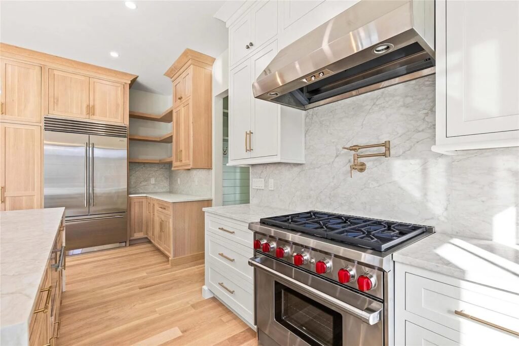 Kitchen with a professional range and natural wood cabinetry