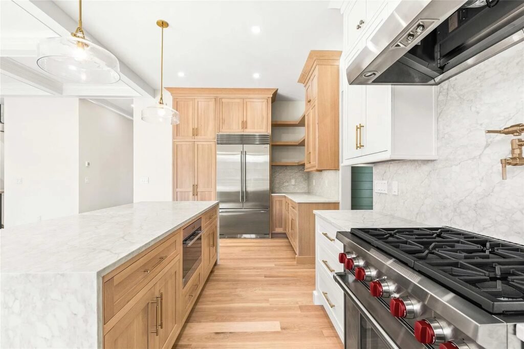 Kitchen with a wood island, marble counters and open shelving