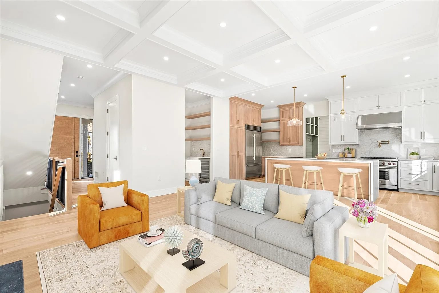 Open-plan kitchen and living area with wide-plank floors
