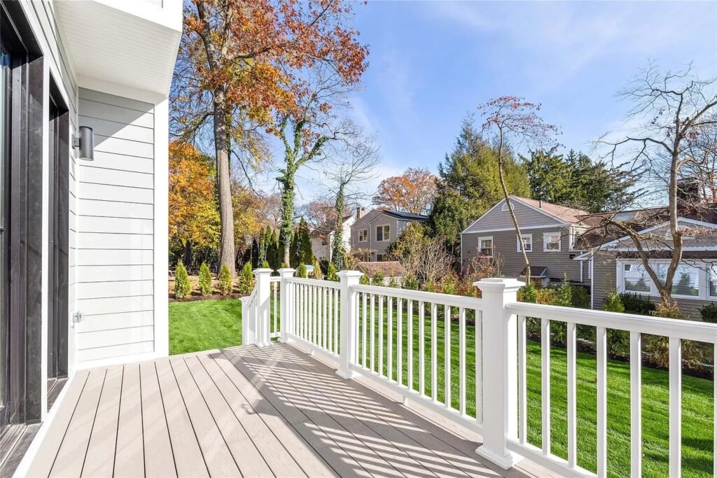 Rear deck with white railing overlooking the yard
